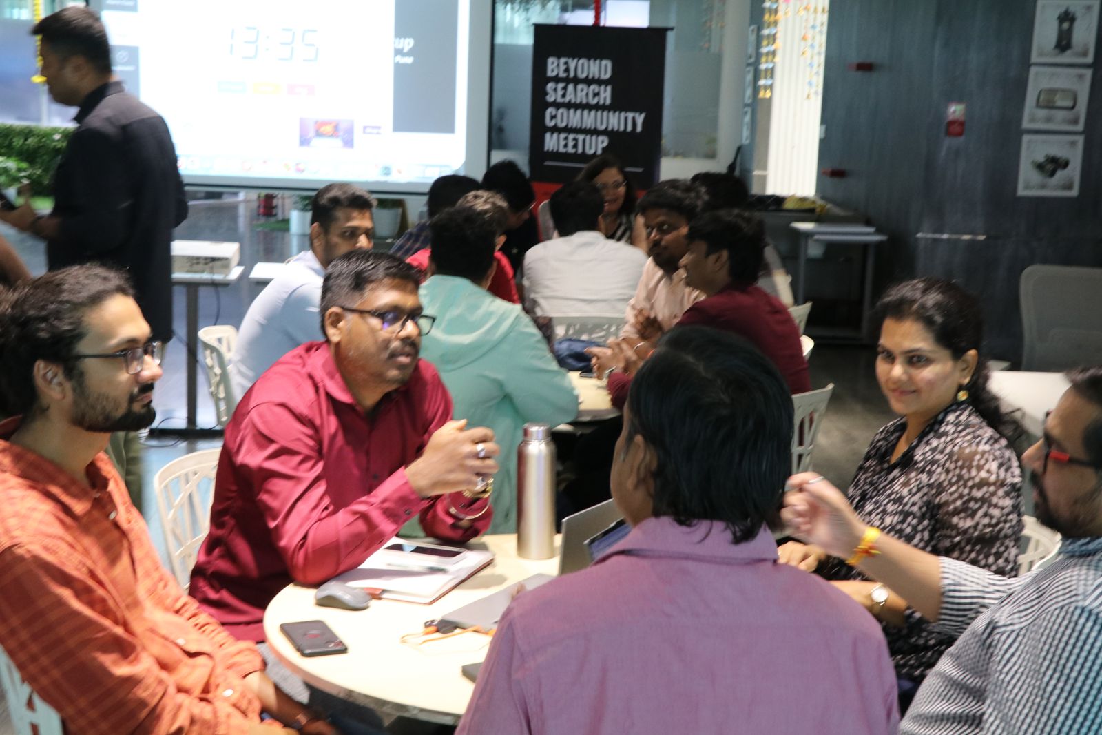 A discussion table beside the Beyond Search Community Meetup banner
