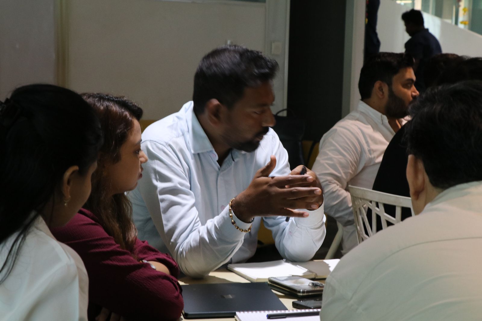 An attendee making a point to his table