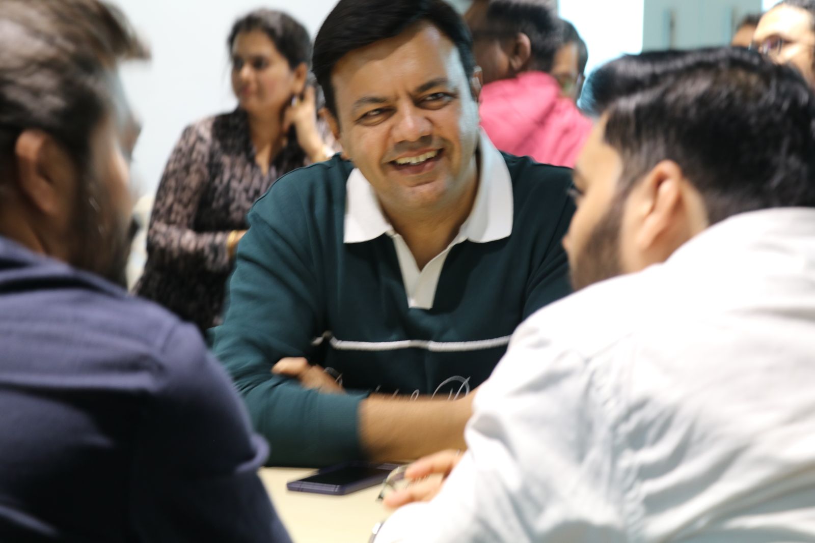 An attendee laughing during a table discussion